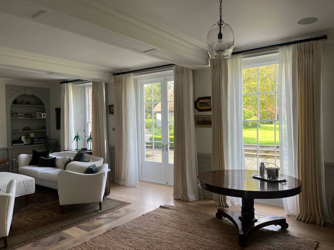 Restored timber French doors and sash windows enhancing natural light in a period property interior
